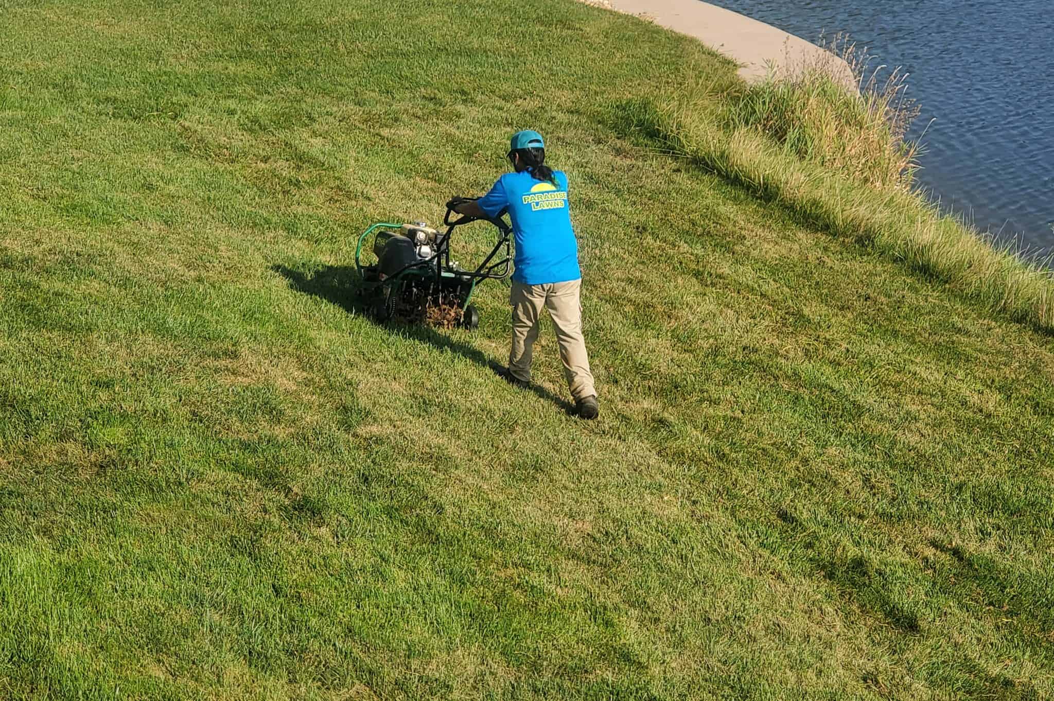 491568267_1159632182842201_6146170613847906262_n Technician providing professional lawn aeration service on a residential lawn in Omaha.